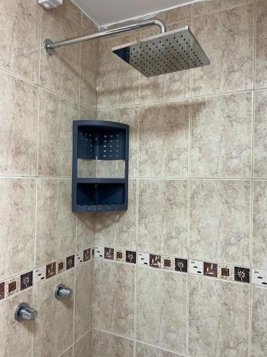 a bathroom with a shower with a shower head at Cozy suite and Jacuzzi overlooking the ocean in Volcán Chimborazo