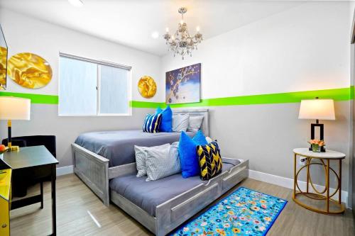 a bedroom with a bed and a couch at A - 3BR NoHo Pad with Patio - Sleeps 12 - Free Parking - 15m to Universal - FIFA World Cup SoFi in North Hollywood