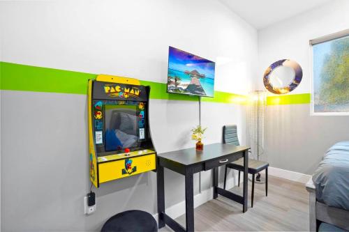 a room with a table and a video game at A - 3BR NoHo Pad with Patio - Sleeps 12 - Free Parking - 15m to Universal - FIFA World Cup SoFi in North Hollywood