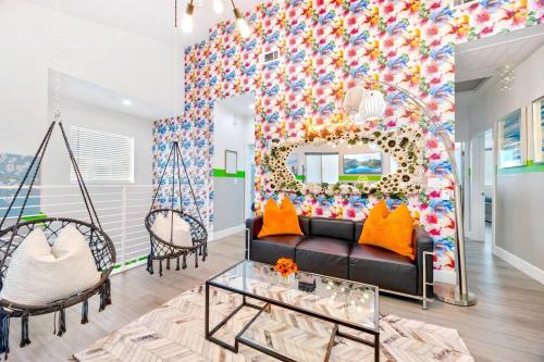 a living room with a couch and a colorful wall at A - 3BR NoHo Pad with Patio - Sleeps 12 - Free Parking - 15m to Universal - FIFA World Cup SoFi in North Hollywood