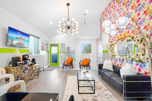 a living room with a couch and a colorful wall at A - 3BR NoHo Pad with Patio - Sleeps 12 - Free Parking - 15m to Universal - FIFA World Cup SoFi in North Hollywood