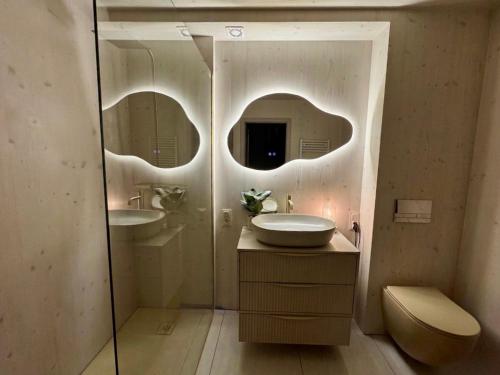 a bathroom with two sinks and a mirror at Cëchô Woda in Parchowo