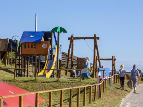 a group of people walking around a playground at DCU-Camping Tranum in Brovst