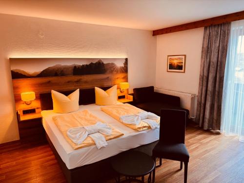 a hotel room with a bed with towels on it at König Ludwig Stub´n in Prien am Chiemsee