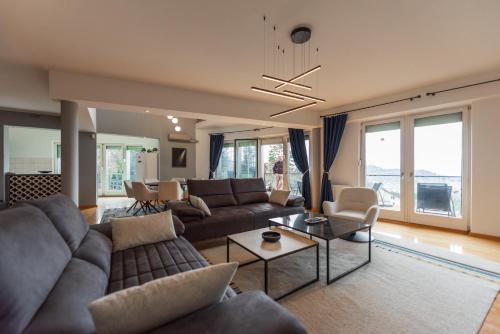 a living room with a couch and a table at Villa Poljine GREEN in Sarajevo