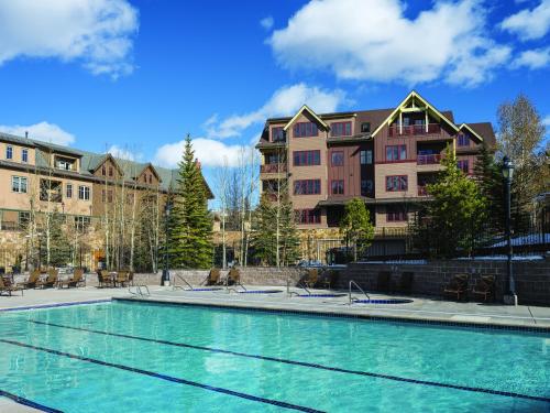 a swimming pool in front of some buildings at The Residences at Main Street Station by Hyatt Vacation Club in Breckenridge