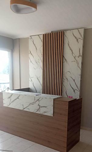 a marble counter in a room with a window at Europa Hotel Korinos in Korinos