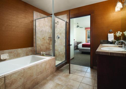 a bathroom with a tub and a shower and a sink at The Residences at Main Street Station by Hyatt Vacation Club in Breckenridge