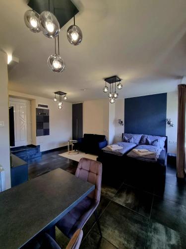 a living room with a bed and a table at MonDa apartman in Salgótarján