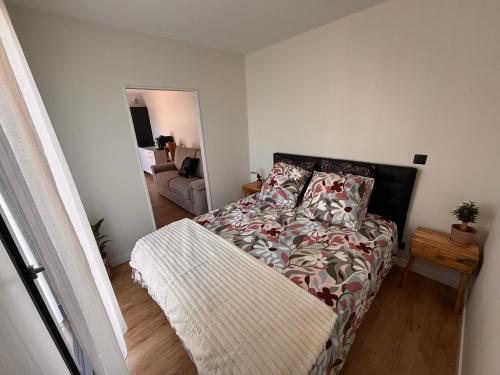 a bedroom with a bed and a couch at La parenthèse boisée in La Chapelle-en-Serval