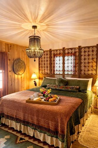 a bedroom with a bed with a tray of food on it at Creekside Paradise in Tybee Island