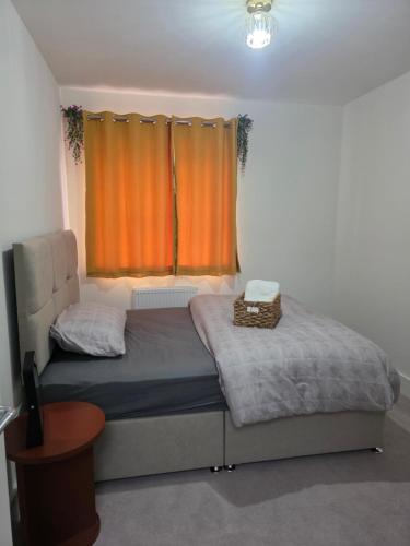 a bedroom with a bed with an orange curtain at HomeAway Comfort in Minster