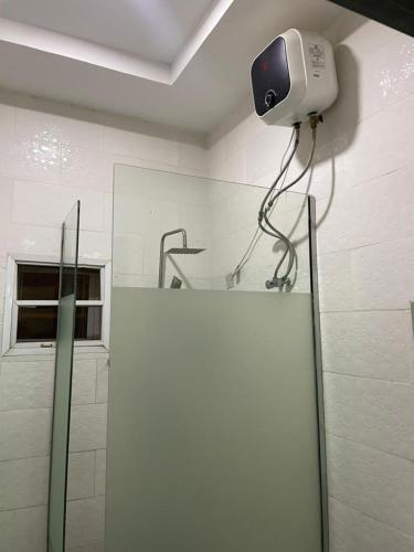 a bathroom with a camera on the wall at Lynstel Apartment & Suites in Abuja
