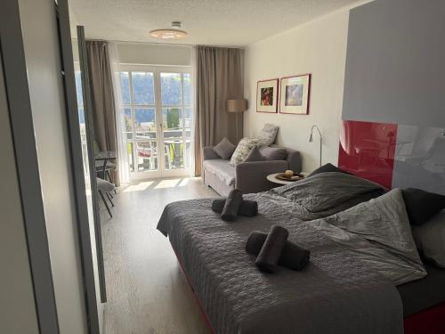 a bedroom with a bed and a living room at Gemütliche Ferienwohnung mit Blick auf die Donau in Obernzell
