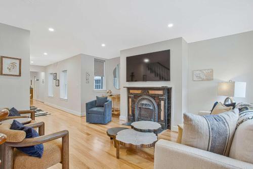a living room with a fireplace and a couch at Luxe Row Home Steps to USNA Gate 3 in Annapolis
