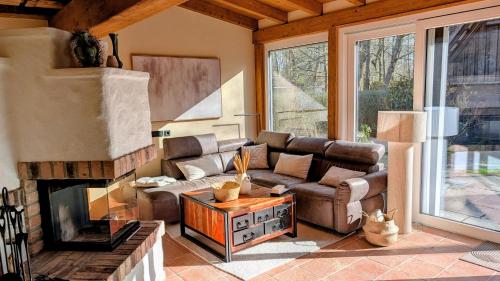 a living room with a couch and a fireplace at Ferienhaus Fließ Paradies mit privatem Saunahaus - Leipe, Spreewald in Leipe