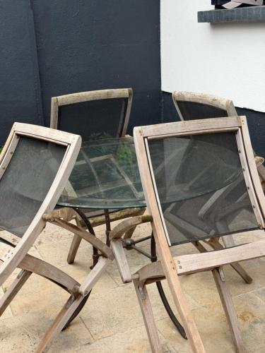 a glass table and two chairs sitting next to each other at The13th in Rueil-Malmaison
