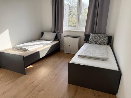 two beds in a room with a window at Ferienhaus von Werner in Schlatt