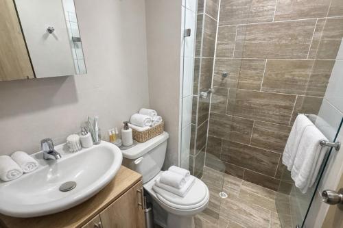 a bathroom with a toilet and a sink and a shower at HOTEL MEDELLIN CENTRAL in Medellín