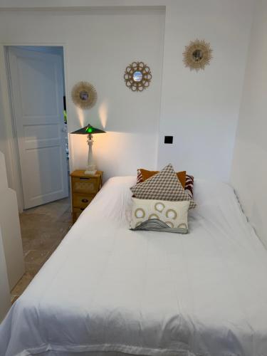 a white bed with pillows on it in a bedroom at The13th in Rueil-Malmaison