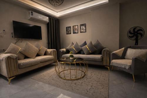 a living room with two couches and a table at Star Luka Private Hotel Room 2 in Luxor