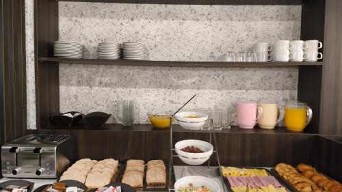 a kitchen with a counter with some food and drinks at Empire Hotel Buenos Aires in Buenos Aires