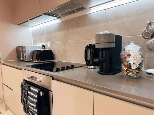 a kitchen with a coffee maker on the counter at Two Bedroom Warm and Cozy Retreat in Exeter in Exeter