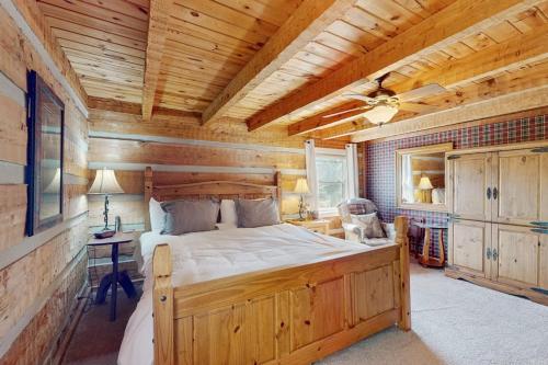 a bedroom with a large bed in a log cabin at Napping Bear Cabin in Banner Elk