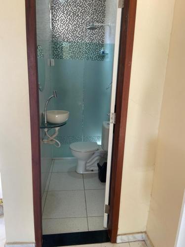 a bathroom with a shower and a toilet and a sink at Casa do Arruda na tabuba in Caucaia