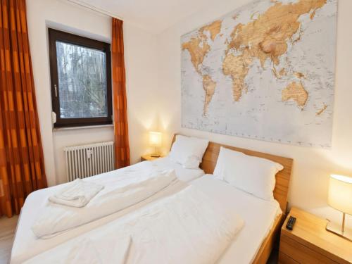 a bedroom with two beds and a map on the wall at Appartement Peter in Freyung im Bayerischen Wald in Freyung