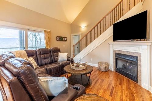 a living room with a couch and a fireplace at Mountain-View Hideaway in Waynesville