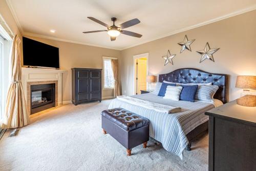 a bedroom with a large bed and a fireplace at Mountain-View Hideaway in Waynesville