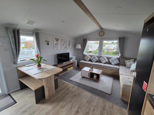a living room with a couch and a table at D&A Southview getaway in Skegness