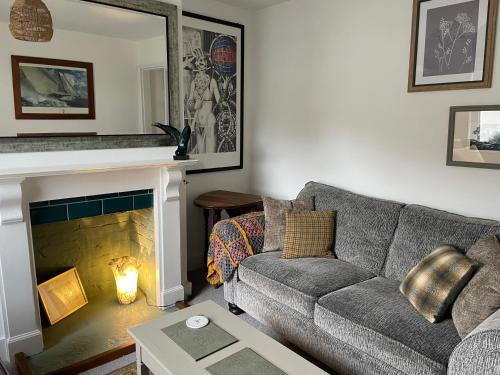 a living room with a couch and a fireplace at No 28 cosy cottage in the heart of Cowes in Cowes