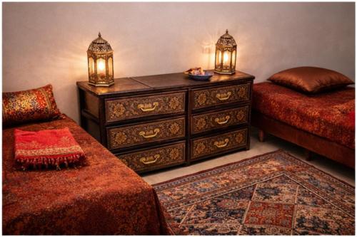 a bedroom with a dresser and a bed and a lamp at Appartement moderne à 5 min de la plage de Mehdia Vacances idéales 2026 in Mehdiya-Plage