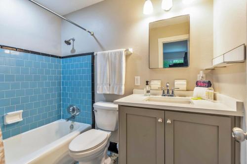a bathroom with a toilet and a sink and a tub at Hill House- Centrally Located, close to everything in Pensacola