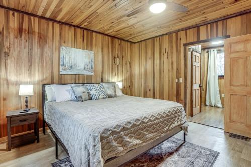 a bedroom with a bed and a wooden wall at Great for Groups! Spacious Melcroft Home w/ Deck in Melcroft