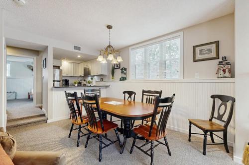 a kitchen and dining room with a table and chairs at Winterplace Getaway A101 in Ludlow