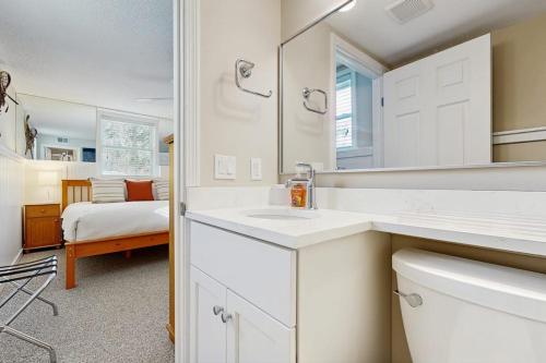 a white bathroom with a sink and a mirror at Winterplace Getaway A101 in Ludlow