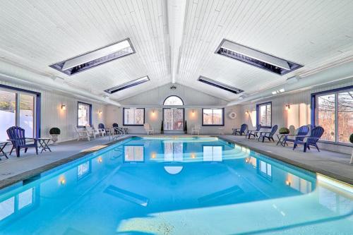 a large swimming pool with blue water in a building at Winterplace Getaway A101 in Ludlow