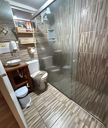a bathroom with a toilet and a sink and a shower at Sua Casa em Noronha - Conforto e Charme na Pousada da Iris in Fernando de Noronha