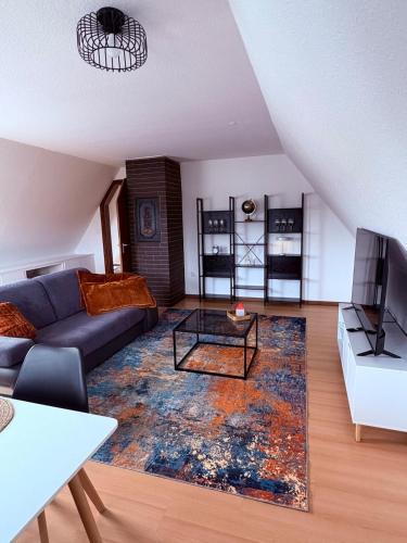 a living room with a couch and a table at Apartment DümmerSee in Hüde