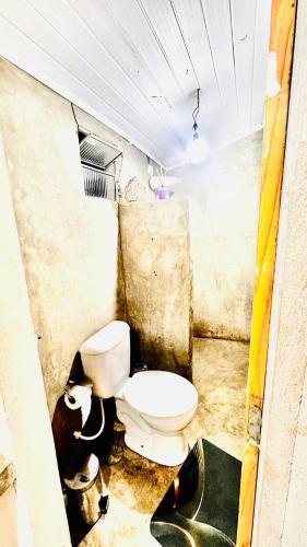a dirty bathroom with a toilet in a room at Kitnet charmosa a 4 min da praia in Porto Seguro