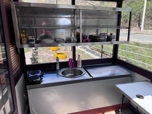 a kitchen with a sink and a counter top at Bujtina Destan Doda in Librazhd