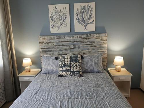 a bedroom with a bed with two lamps on both sides at Turtle's Nest in Margate