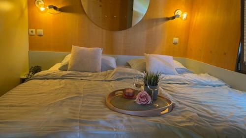 a large bed with a tray on top of it at HappyPlace - Kolpa PremiumMobileHome in Metlika
