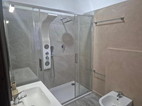 a bathroom with a shower and a sink and a toilet at Villa Criade in Castelsardo