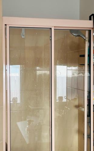 a glass door of a cabinet in a room at ABC Homes Nedlands in Doncaster East