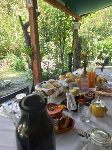 a table with food and drinks on top of it at Pousada Oliveira Ramos in Lumiar
