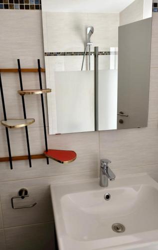 a bathroom with a sink and a mirror at Apartment Central Mutters Innsbruck in Innsbruck